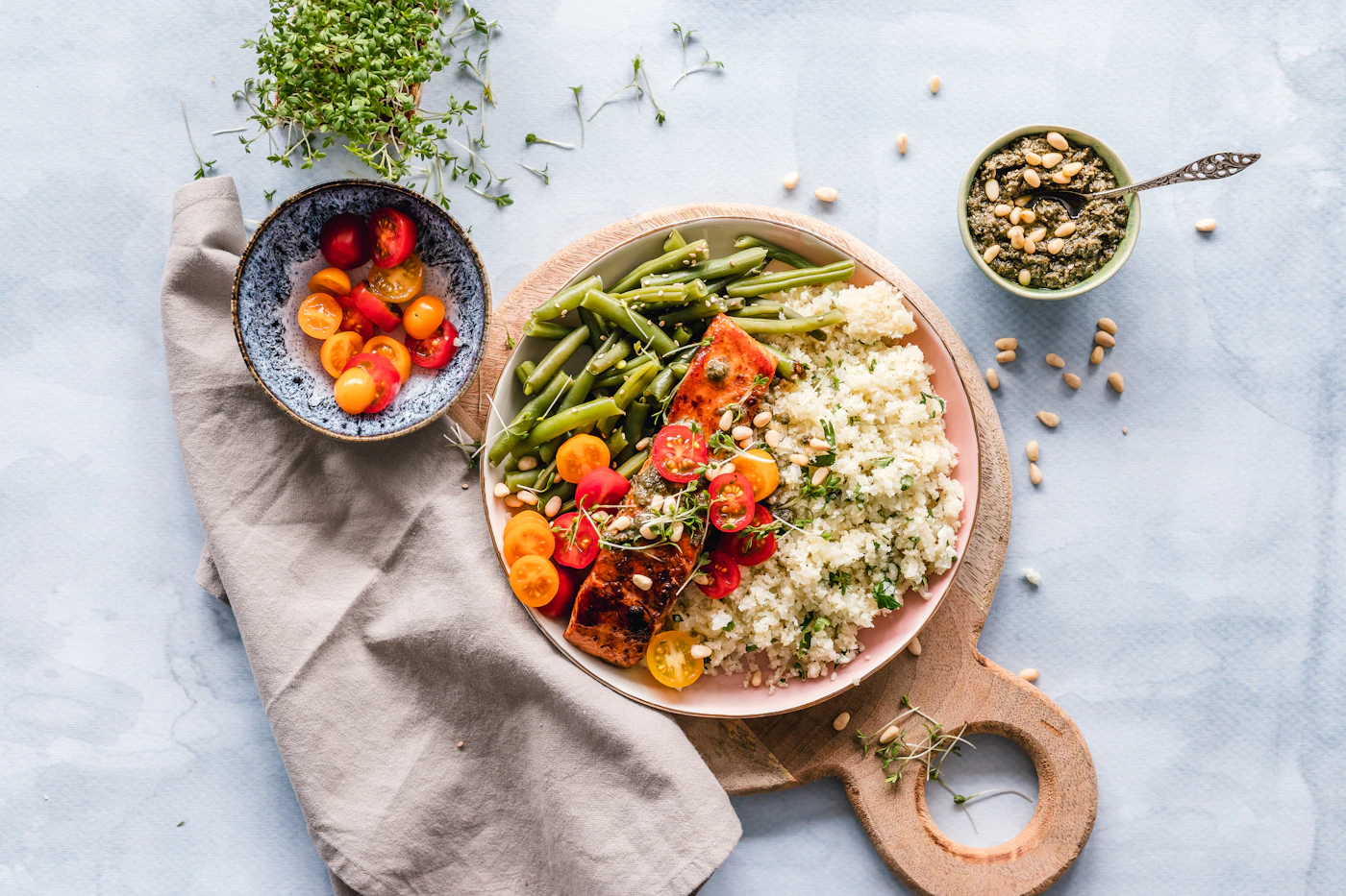 A bowl of grains and vegetables on a pale tabletop