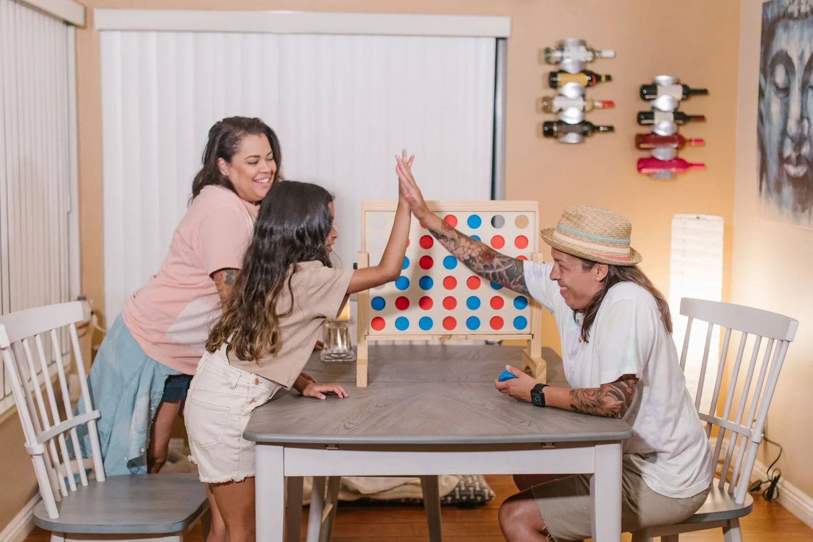 People playing a colorful tabletop game together.