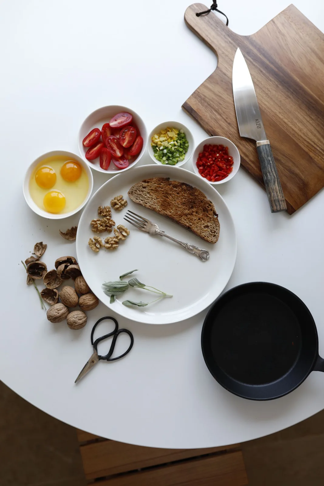 Eggs, bread and ingredients arranged on a breakfast preparation table